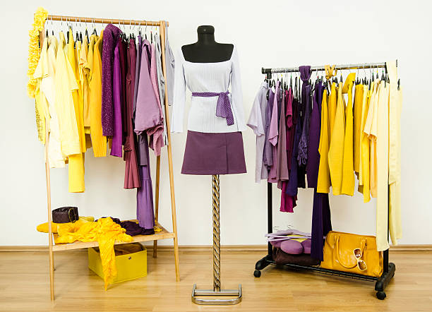 istock Wardrobe with complementary colors violet and yellow clothes. 518150833