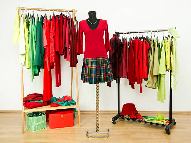 istock Wardrobe with complementary colors red and green clothes on hangers. 518151033