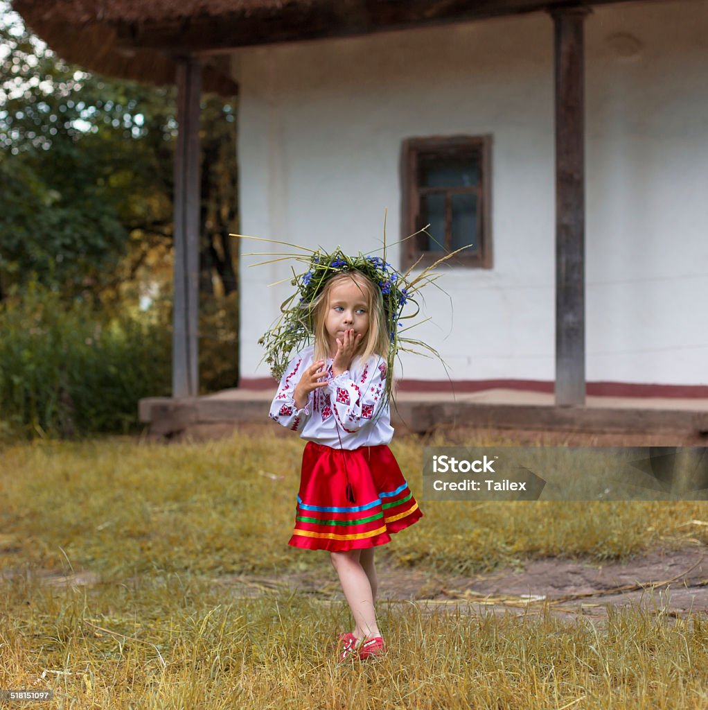 Girl in coronett and national costume little girl in couronne from flowers in national costume Baby - Human Age Stock Photo