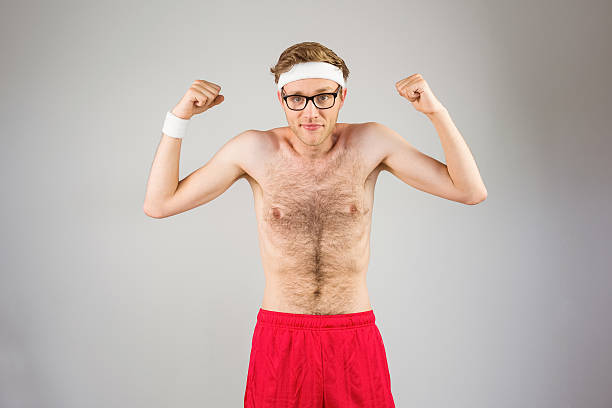 istock Geeky shirtless hipster flexing biceps 518151173