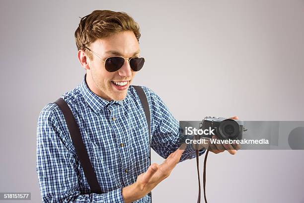 Geeky Hipster Holding A Retro Camera Stock Photo - Download Image Now - 20-29 Years, 25-29 Years, Adult