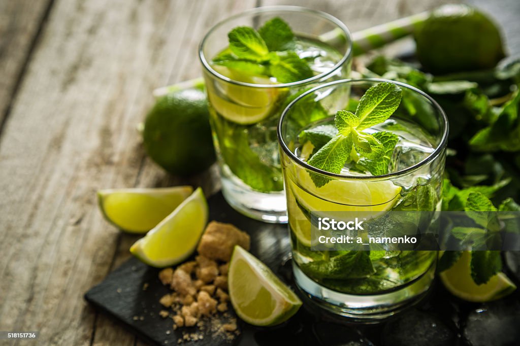 Mojito cocktail and ingredients Mojito cocktail and ingredients, rustic wood background, copy space Mojito Stock Photo