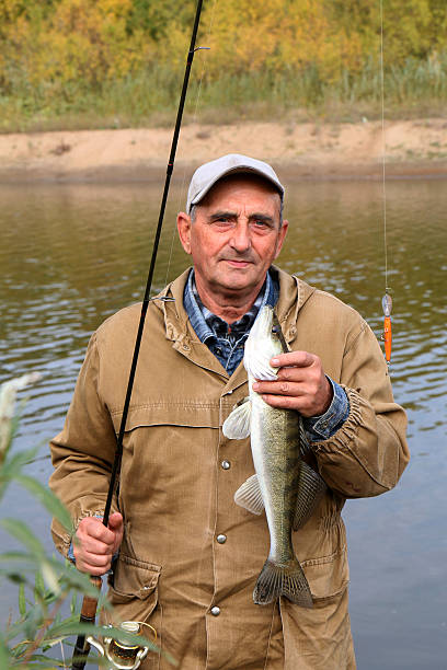 istock old fisherman and his catch - zander 518152761