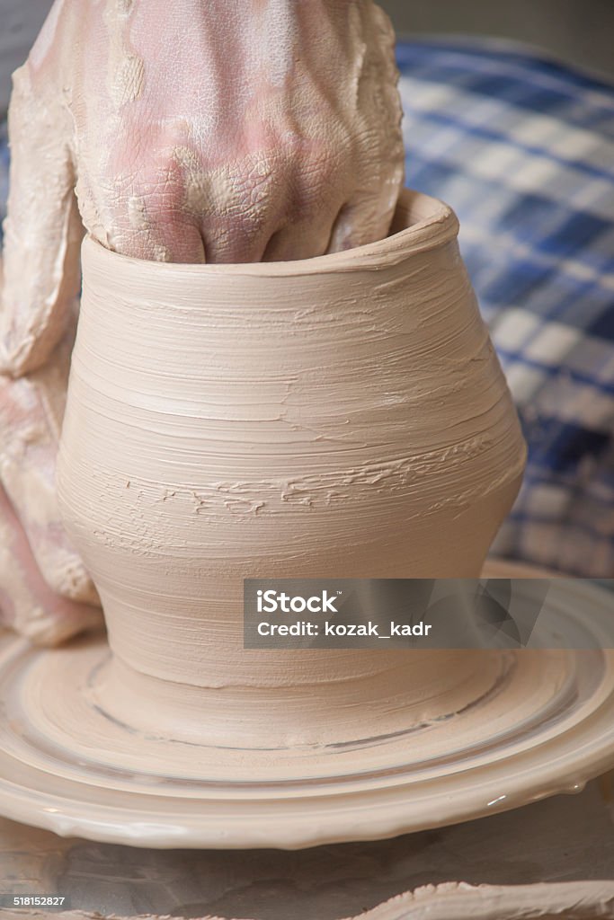 Hands of a potter Hands of a potter, creating an earthen jar on the circle Art Stock Photo