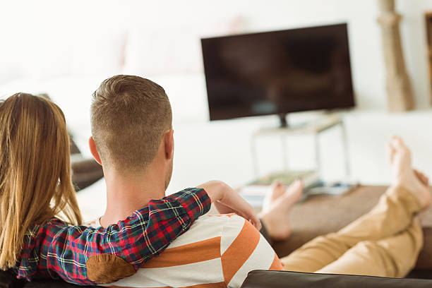 istock Cute couple relaxing on couch 518154613