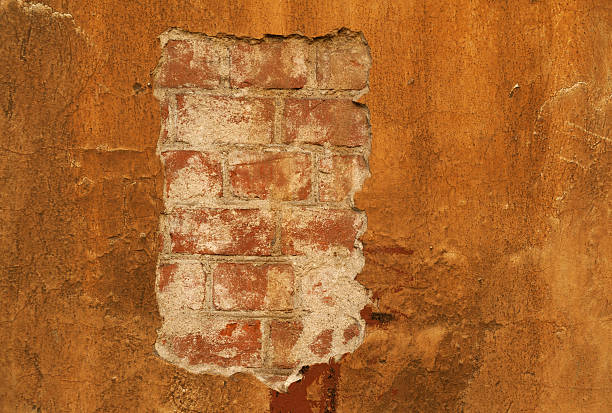 istock Texture of old  wall covered with yellow stucco 518169755