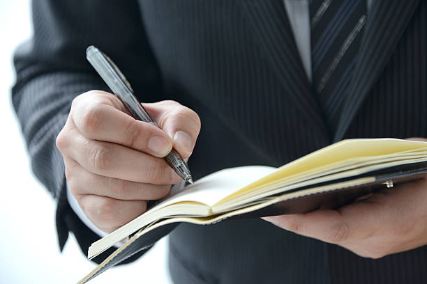 istock Business man writing on personal organizer 518169833