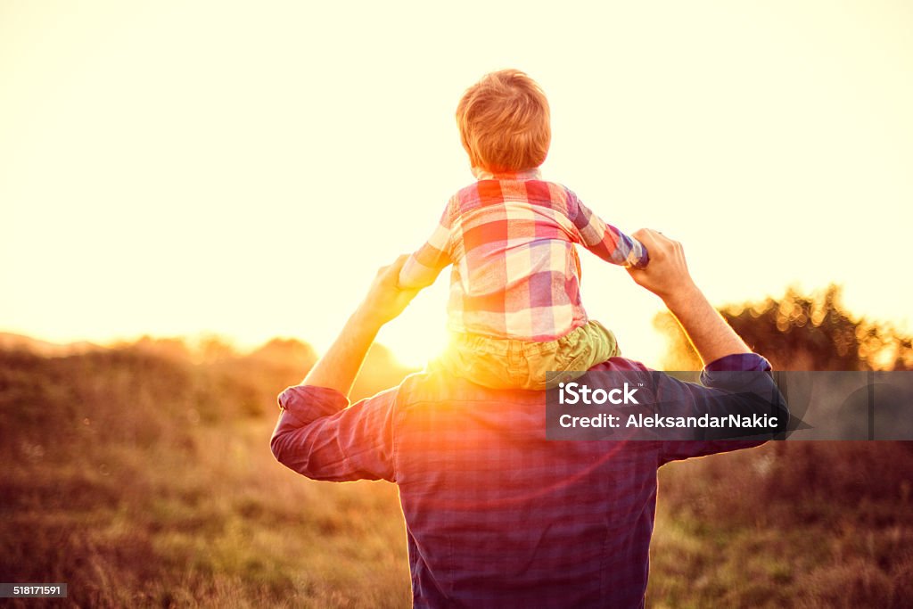 Piggyback ride Father and son Family Stock Photo