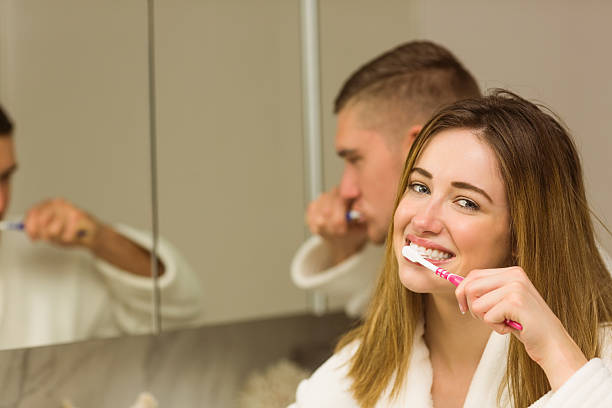 istock Cute couple brushing their teeth 518172023