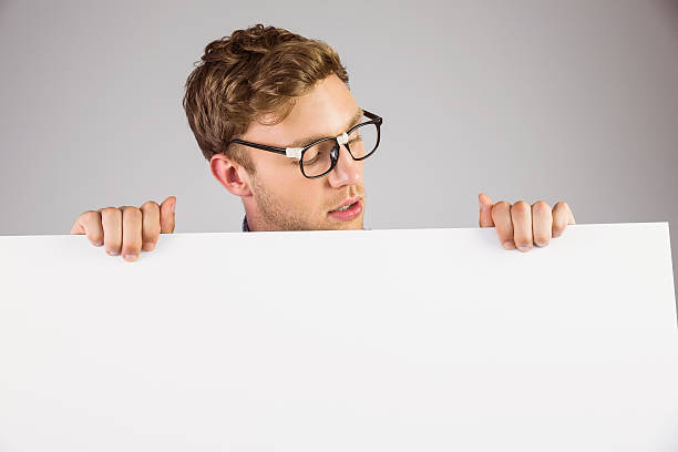 istock Geeky hipster showing a card 518172239