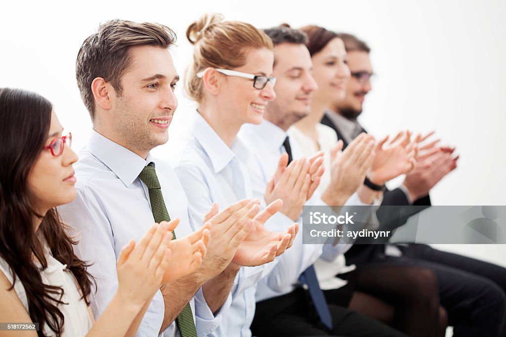Motivated business people A line of businesspeople applauding a great presentation. Adult Stock Photo