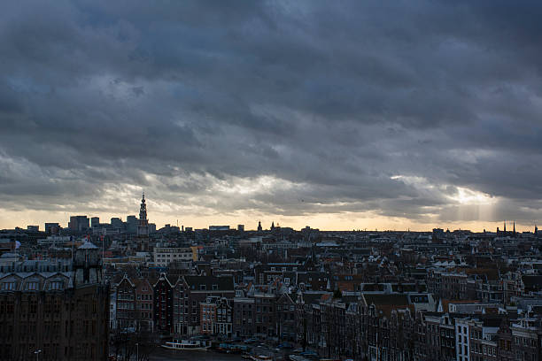 istock Grey clouds with sun over the european city 518172982