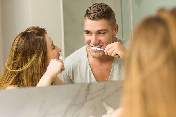istock Cute couple brushing their teeth 518173425