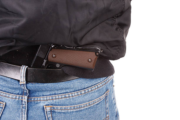 istock back view of robber with handgun 518173579