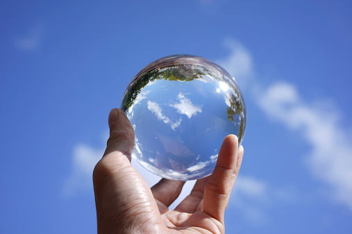 Focus on taking care of nature and the climate shown with nature encased in a crystal ball