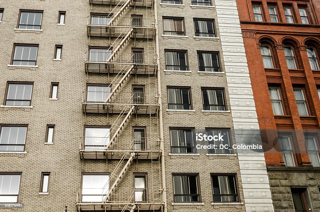 Brick and Fire Escape Two different color brick buildings, one with a fire escape running down the side of it in Portland, Oregon Architecture Stock Photo