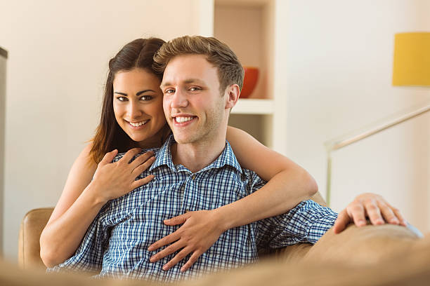 istock Happy young couple relaxing on the couch 518174961
