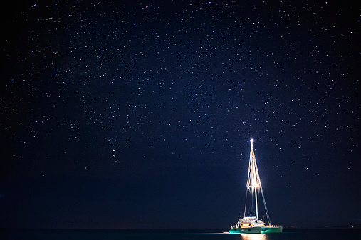 boat at anchor at night under the stars