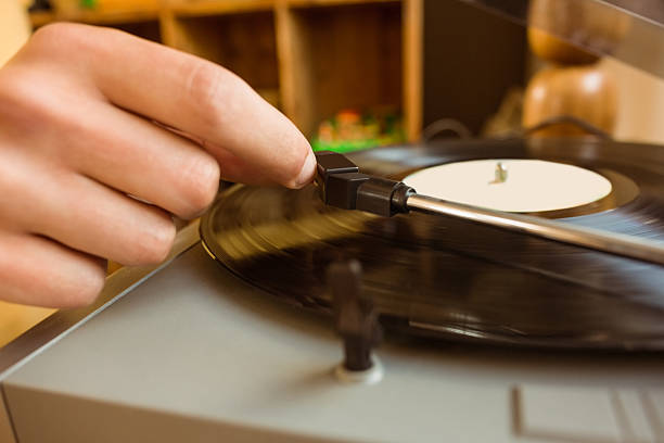 istock Young man putting on a vinyl 518176861