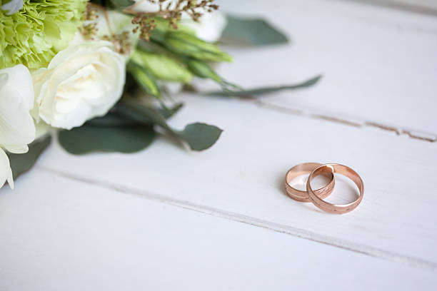 istock The wedding rings with white roses 518177436