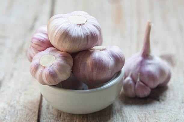 istock Garlic on wood table with morning light, soft focus 518177884