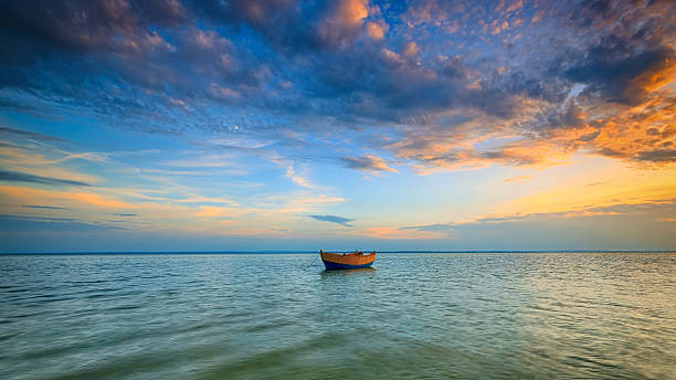 istock Lonely boat on the Baltic Sea at sunset. 518178566