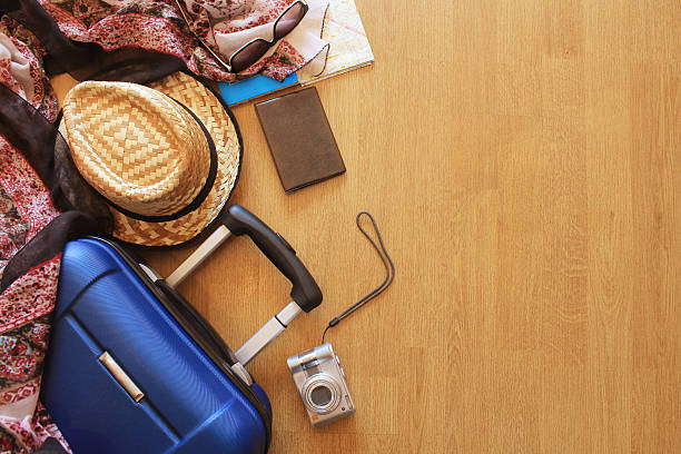 istock Suitcase and tourist stuff  on wooden background 518180250