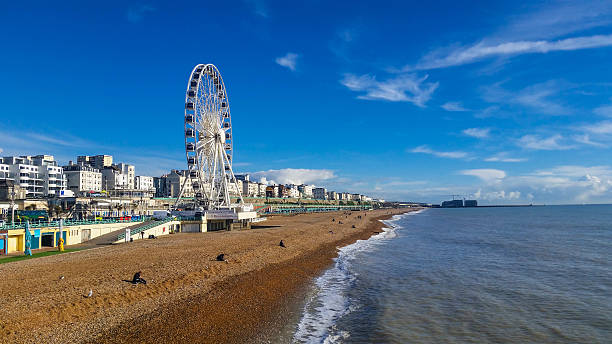 Brighton Ferris Wheel Beachfront - Panoramic view Brighton Ferris Wheel Beachfront - Panoramic view channel islands england stock pictures, royalty-free photos & images