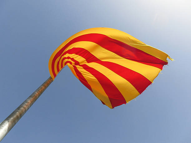 Catalonian flag waving in front of the sky. The photo was taken in Barcelona. 