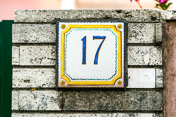 istock Brick wall with plate number seventeen 518183482