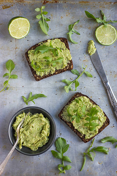 istock rye toasts with guacamole and arugula on rustic  background 518183550