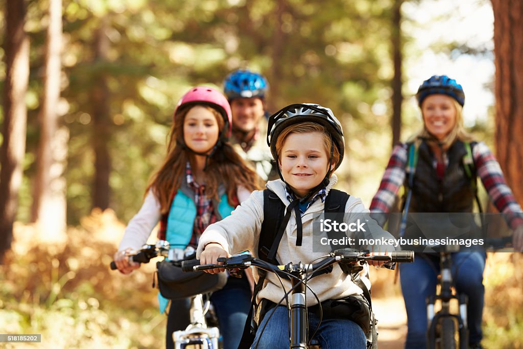Family mountain biking on forest trail, front view, close-up Family Stock Photo