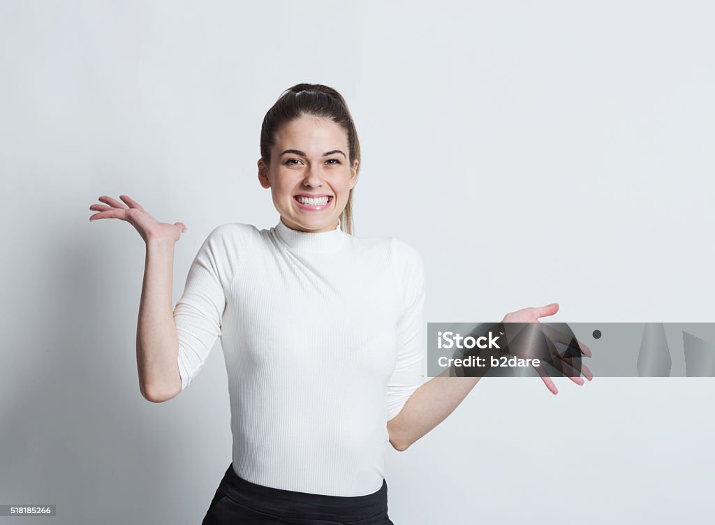 Excited woman Close-up portrait of surprised beautiful girl holding her head in amazement and open-mouthed. Over white background. Sideways Glance Stock Photo