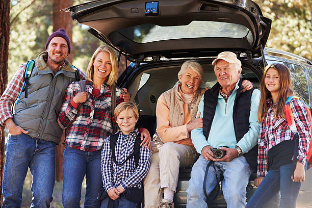istock Multi generation family standing by a car before forest hike 518185936