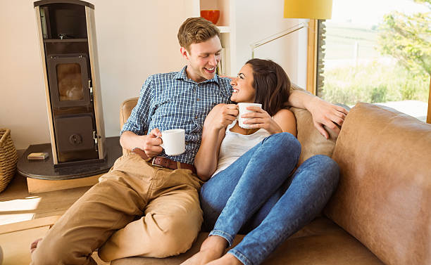 istock Happy young couple relaxing on the couch 518197849