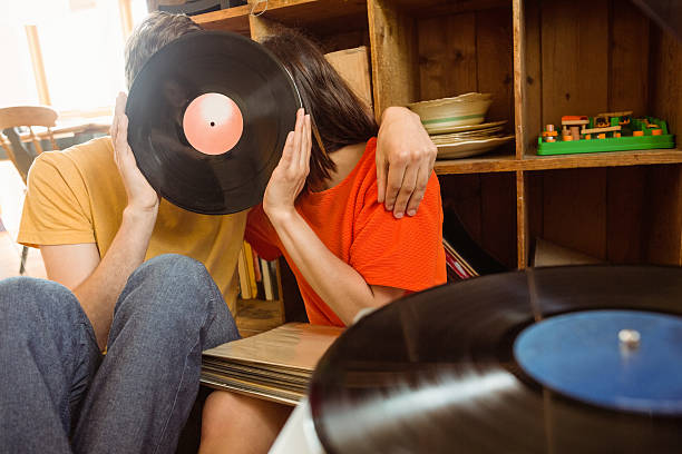 Young couple listening to vinyl record