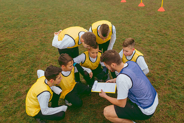 istock Kids Talking With Their Coach About Soccer Strategy 518198052