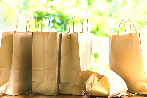 Organic bread and paper shopping bags in a row