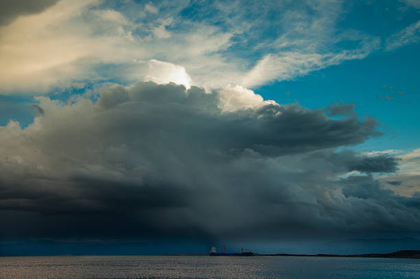 freighter with big storm on it cargo ship with storm above beagle channel photos stock pictures, royalty-free photos & images