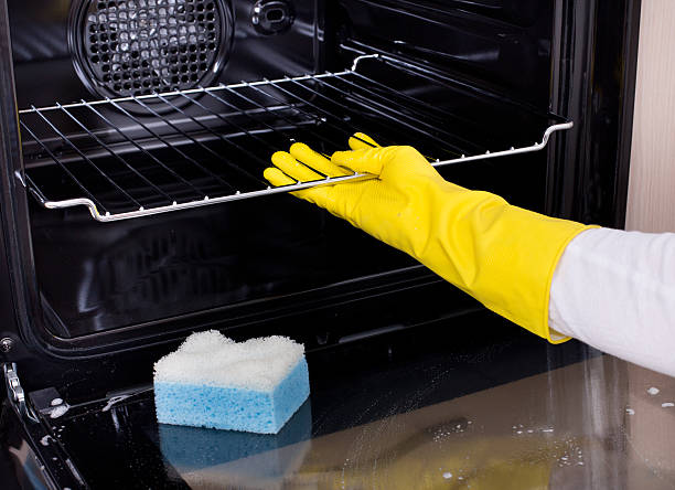 istock Woman cleaning oven 518198622