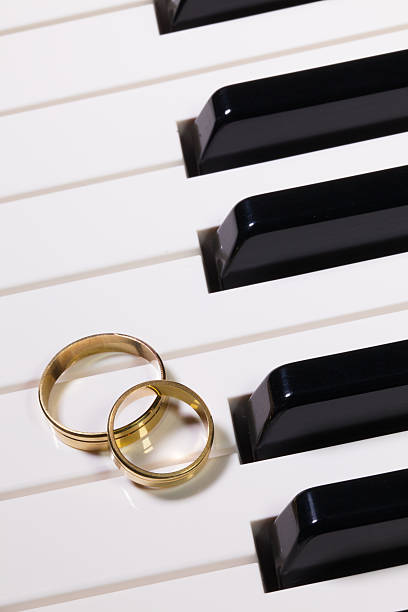 istock Piano keyboard and wedding rings 518198998