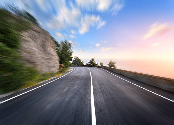 istock Mountain road in motion blur effect at sunset 518199880