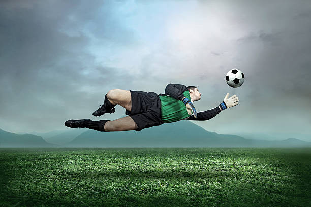istock Goalkeeper with ball in action outdoors 518200039