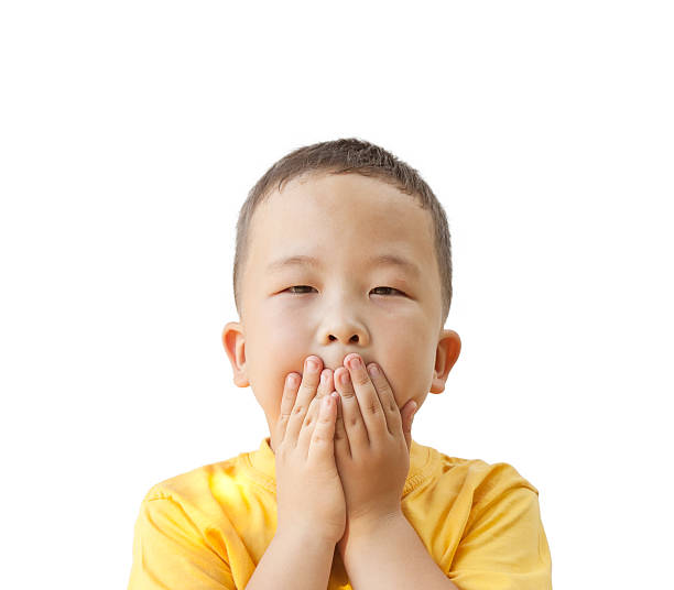 istock boy closes mouth hands, isolated on white background 518200379