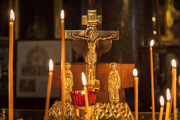 istock Icon lamp with Jesus on cross and burning candles 518201221