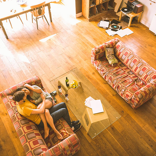 istock Young couple cuddling on the couch 518201919