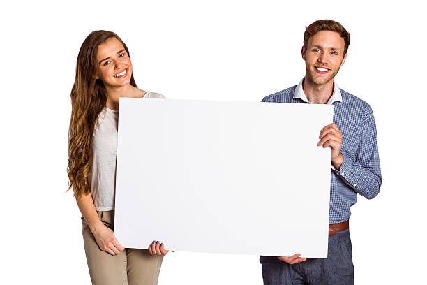 istock Happy young couple with blank board 518202551
