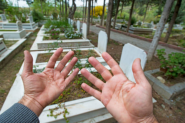 istock Muslim man hands praying near the grave 518203266