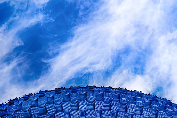 Background with blue bike tire against cloudy sky
