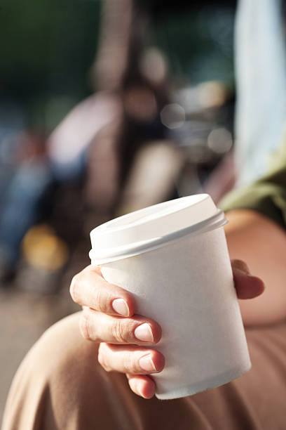 istock Young woman drinking coffee from disposable cup 518204055